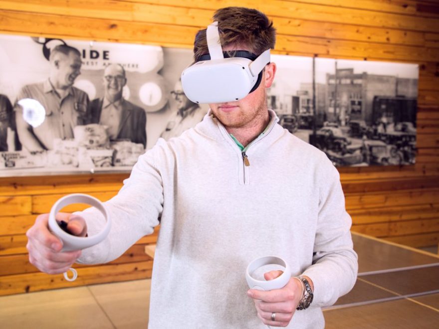 Team member using virtual reality goggles to view immersive 360 of broiler research farm